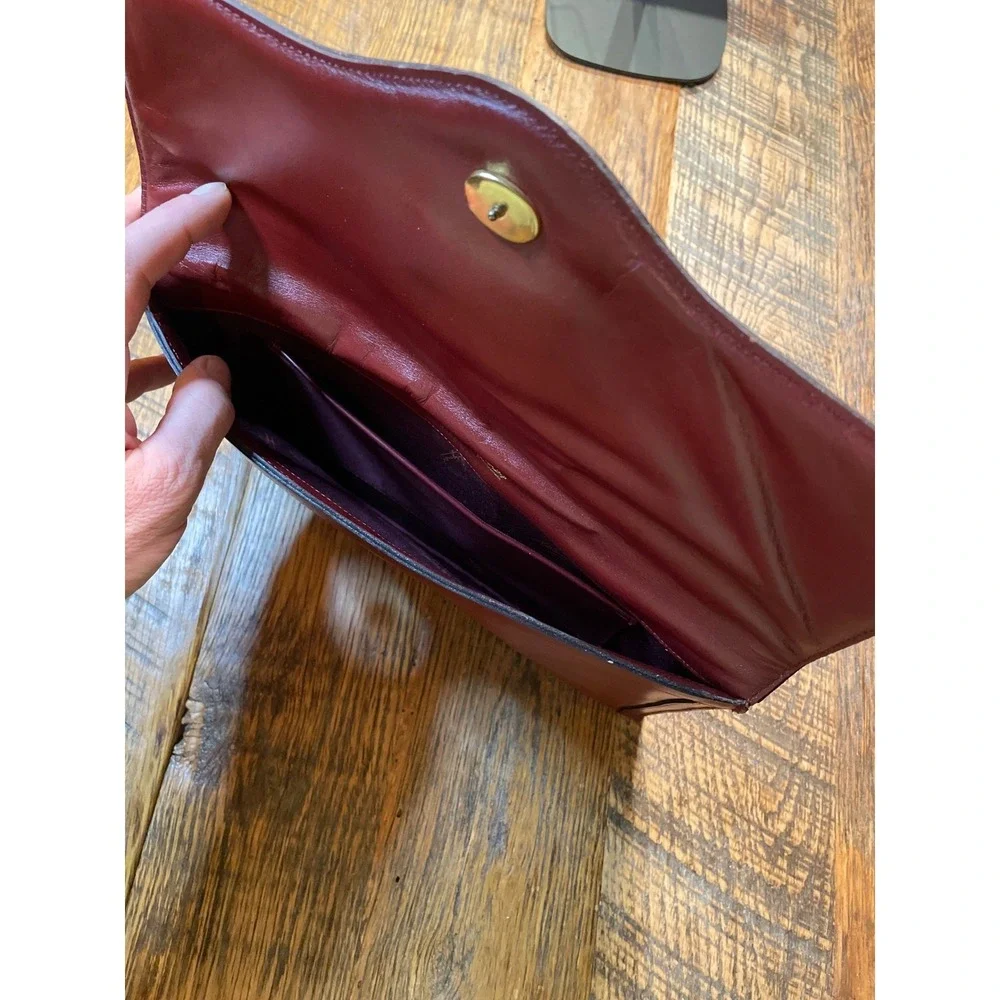 Elegant‎ Burgundy Etienne Aigner Leather Clutch Handbag with Gold Oval Accent